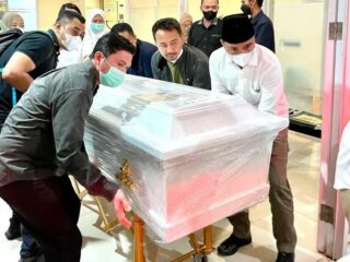 Bupati Boltim Sam Sachrul Mamonto, saat ikut bersama keluarga mengangkat peti jenazah Almarhum Om Oku ke dalam ambulance.(Foto: ist)