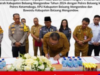 Pj Bupati Bolmong Limi Mokodompit Tanda Tangani NPHD Pilkada 2024